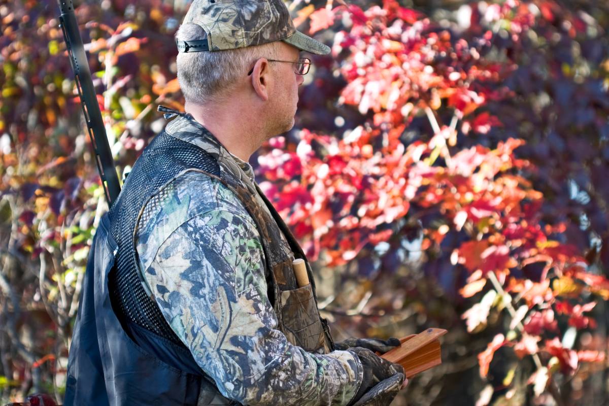 A male hunter wearing camouflage and using the easiest turkey call, a box call